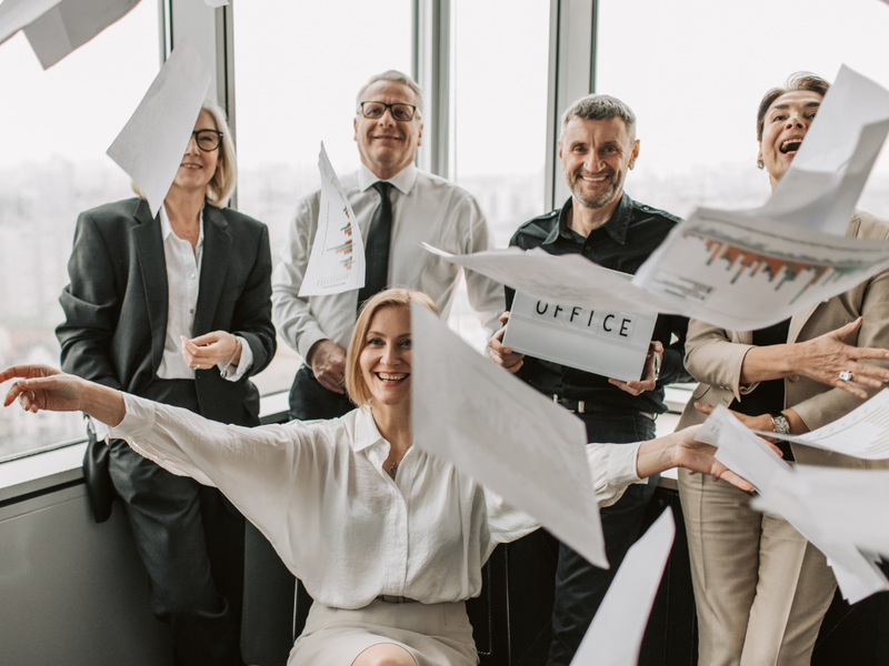 team throwing papers